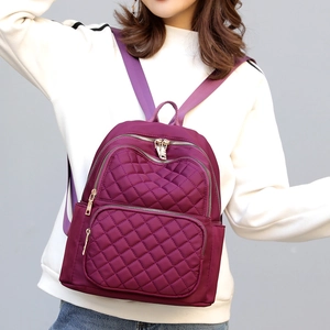 Stylish purple nylon backpack for women with quilted diamond pattern and gold zippers