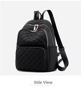Detailed side view of black quilted nylon backpack with elegant gold zippers and hardware