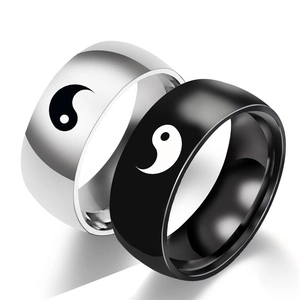 Macro detail of Yin Yang couple rings in polished black and silver stainless steel