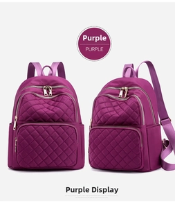 Detail of purple waterproof nylon backpack featuring diamond quilted patterns and gold zippers