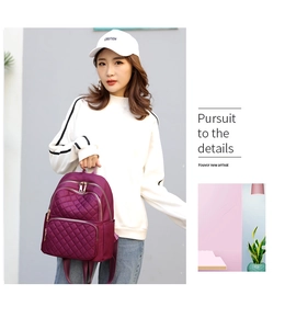 Fashionable purple quilted nylon backpack for women shown in lifestyle context