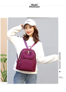 Fashionable purple quilted nylon backpack for women with waterproof finish shown on model