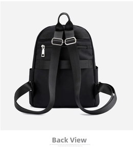 Back view of lightweight nylon backpack featuring adjustable straps and a zipper pocket