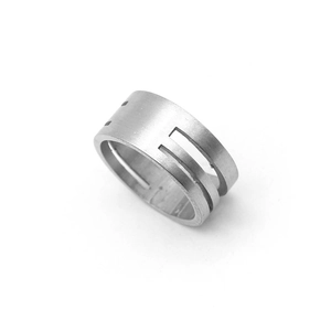 Macro view of silver brushed metal jump ring opener tool with geometric hollow design