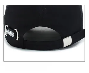 Close-up of black cotton baseball cap rear with adjustable strap and metal buckle