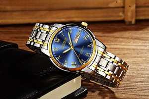 Detail of quartz watch with blue sunray dial and dual calendar on leather notebook