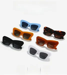 Flat lay showing six colorful cat eye sunglasses with thick frames and UV lenses