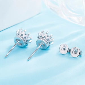 Macro view of crown-shaped sterling silver stud earrings with S925 hallmark