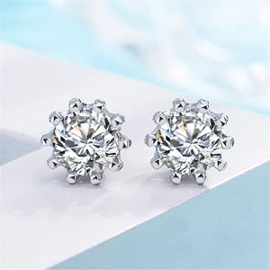 Macro shot of silver stud earrings with a crown-set sparkling round cubic zirconia