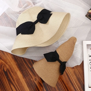 Cappelli di paglia pieghevoli da donna a tesa larga con fiocchi neri in beige e marrone
