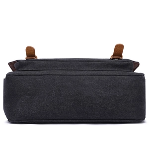 Bottom view of black canvas briefcase with leather straps and professional texture