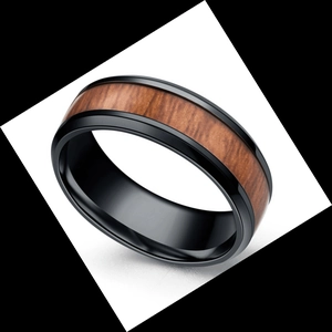 Close-up of black titanium men's ring featuring detailed wood grain inlay on white background