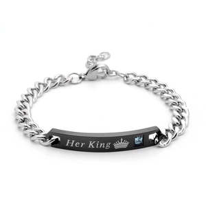 Macro view of silver stainless steel Cuban chain bracelet with Her King engraved tag