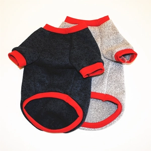 Detail view of navy and grey dog fleece sweaters with red ribbed cuffs and warm texture