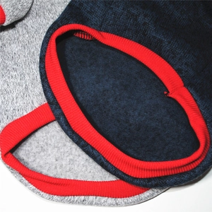 Detailed macro view of dog fleece hoodie featuring navy fabric and red ribbed collar sewing