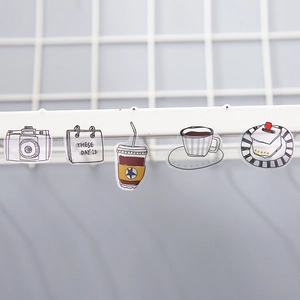 Watercolor stationery stickers featuring lifestyle icons on a white metal grid display