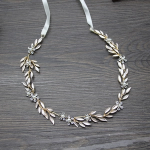 Détail d'un bandeau de mariée avec feuilles en émail, perles et cristaux sur bois