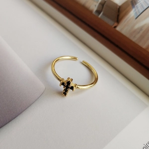 Close-up of S925 hallmark on gold plated sterling silver cross ring with black zircons