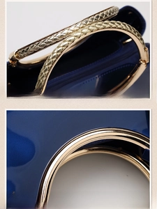 Detail of blue patent leather bag showing woven handle and gold-plated metal hardware
