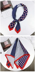 Detail of red and navy silk scarf with floral patterns and contrast borders