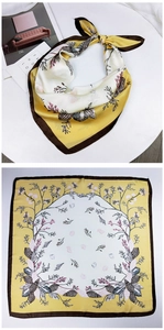 Detailed view of yellow floral silk square scarf showing shell prints and neat edge stitching