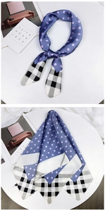 Detail of elegant polka dot and checkered silk scarf with premium stitching and texture
