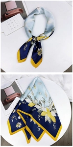 Detail of silk-feel square scarf with blue shell patterns and yellow contrast borders