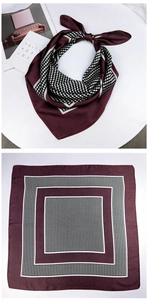 Close-up of wine red silk scarf featuring white polka dots and geometric borders