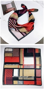 Macro detail of square silk scarf showing geometric patterns and vibrant color blocking