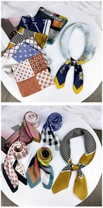 Detail view of various printed silk scarves with floral, polka dot, and geometric patterns