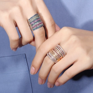 Close-up of stacked gold and silver rings set with multicolored AAA zircon stones