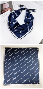 Navy blue silk-textured square scarf featuring white typography print and elegant drape