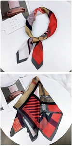 Detailed close-up of a satin square scarf featuring geometric red and black patterns