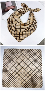 Detailed view of champagne silk square scarf featuring black grid patterns and red dots