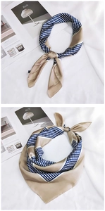 Close-up of elegant silk square scarf with navy polka dots and champagne border