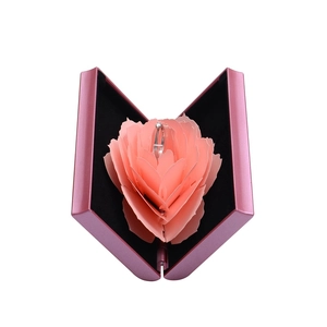Pink rotating rose ring box with a 3D pop-up flower structure for wedding proposals