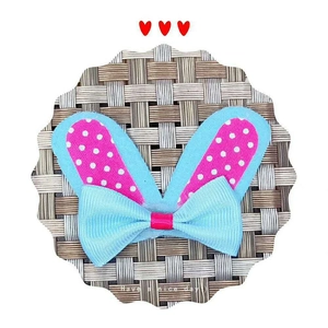 Detail of pink polka dot rabbit ears and light blue ribbon bow DIY craft accessory