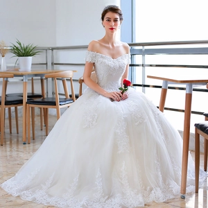 Elegant white off-the-shoulder wedding dress with lace embroidery and starry tulle skirt