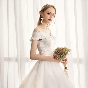 Elegant off-shoulder white lace wedding dress with layered tulle skirt and vintage style