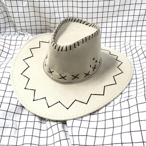 Detailed top view of beige suede cowboy hat featuring black cross stitching and wave patterns