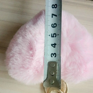 Detail showing the 8cm width of a pink plush heart keychain with gold metal ring
