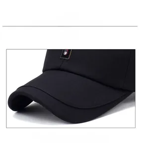 Detailed close-up of a black baseball cap featuring reinforced brim and fine stitching
