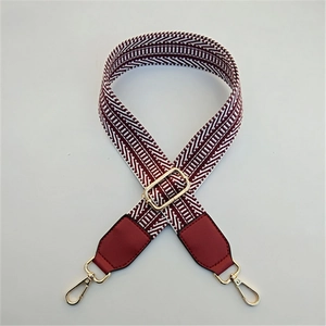Adjustable colorful wide woven shoulder strap with geometric wave pattern and gold clasps