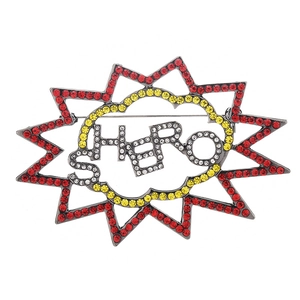 Pop art style Hero word brooch featuring red and yellow rhinestones on white background