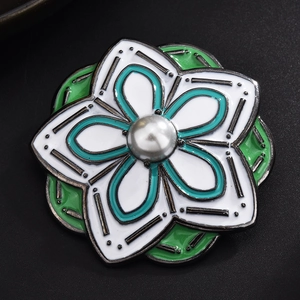Elegant floral brooch with white and green enamel petals and a central pearl accent