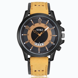 Close-up of SOKI sports watch with yellow suede strap, date window and black numeric dial