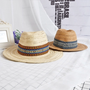 Ethnic style straw sun hats with geometric bands in natural beige and khaki colors