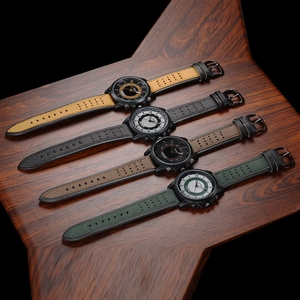 Detail of four men's military watches with yellow, black, brown and green leather straps