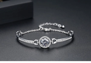 Macro shot of silver-toned bangle featuring a circular pavé-set centerpiece and sparkling crystals