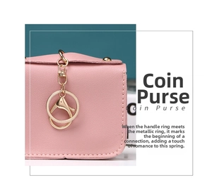 Detail of pink leather coin purse featuring a golden circular metal ring and clasp